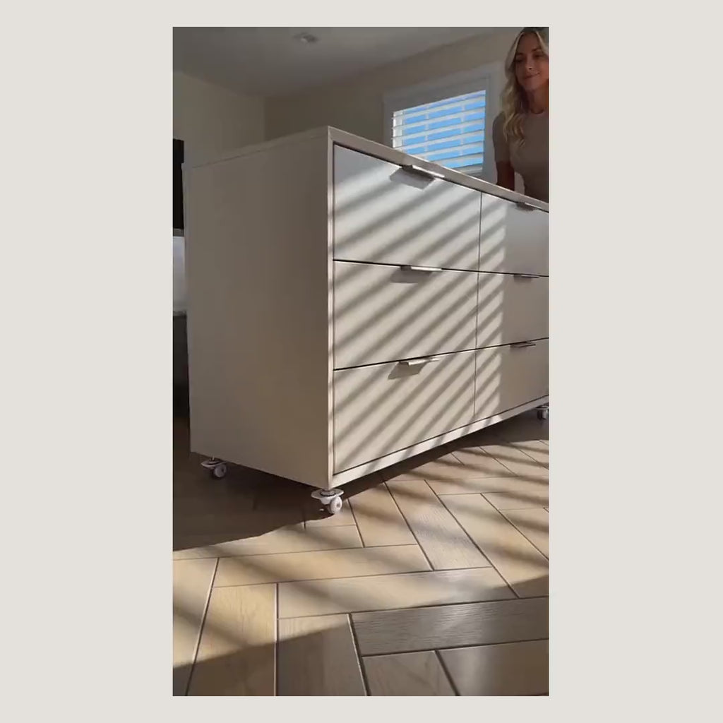 Demonstration: stick-on mini swivel wheels attached under a bin and a basket so they roll across the floor
