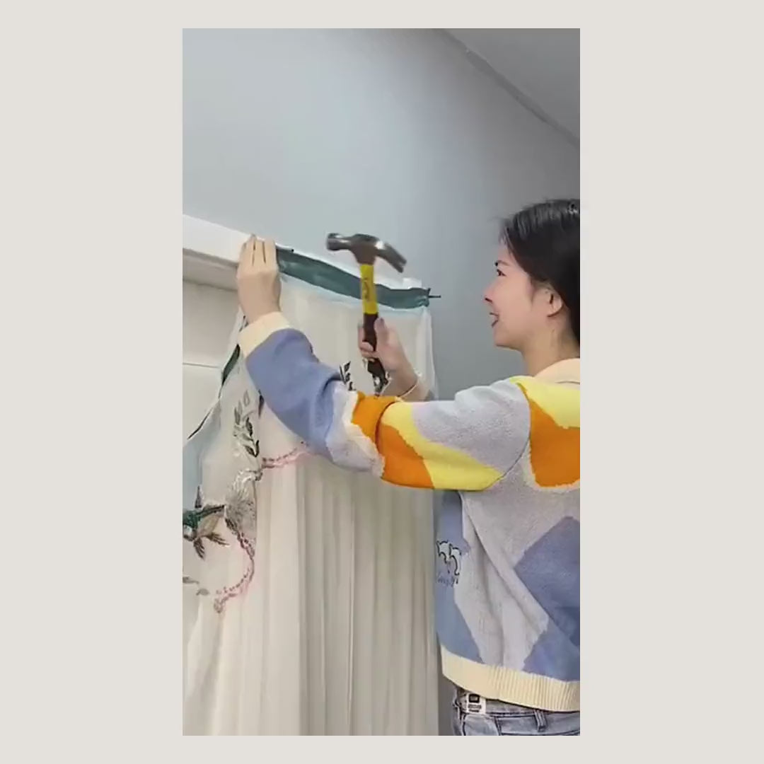 Demonstration: the self-adhesive rod clip in this kit stuck to a frame and a curtain rod dropped in